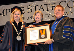 Acting President Meg Benke, left with the college’s Presidential Medal recipient and Stewart’s Foundation President Susan Dake, and Hugh Hammett, the college’s vice president for external affairs.