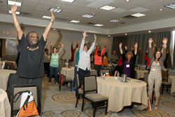 Students stand up and stretch at the 2015 Student Wellness Retreat