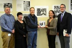 Agnes Zellin ’82 and Paul Tick ’75, holding the exhibit book, were joined by Dean Gerald Lorenz, far left, Secretary Ginger Schwartz and Tom Mackey, vice provost for academic services, standing far right. Photo/Empire State College