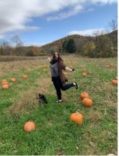 Photo of Callie Montalvo-Patel in a pumpkin field