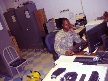 A photo of a man in the army sitting at a desk