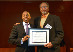 Khalil Gibran Muhammad, director of The Schomburg Center for Research in Black Culture, a research unit of The New York Public Library, presents Walter Dean Myers ’84 with the Distinguished Alumni Award.
