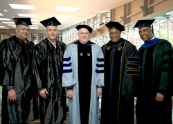 Student, alumni and faculty representatives for the BMI scholarship gathered at the 2013 Metropolitan Center graduation. From left to right they are: Student Lawrence H. Johnson, Keith Amparado ’88, Professor Robert Carey, Professor David Fullard and Jay Marshall ’06, ’08. (Photo/Marty Heitner)