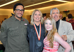 Graduate Margarita DeJesus is joined by her son David DeLarosa, left in glasses, her father Juan DeJesus and her proud daughter Sara DeJesus at the reception for Center for Distance Learning graduates.
