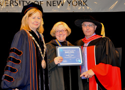 Mentor Cynthia Bates, center, is presented with the Chancellor’s Award for Excellence in Teaching by Acting President Meg Benke and Dean Gerald Lorentz at the college’s recent Northeast Center graduation ceremony.