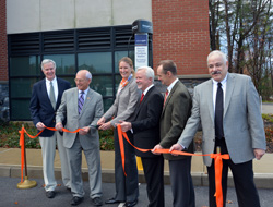 SUNY Empire State College President Merodie A. Hancock is joined by William Flaherty of National Grid, far left, Rep. Paul D. Tonko, Scott Johnson, mayor of Saratoga Springs, Mark Torpey of NYSERDA and Andy Balmuth of ChargePoint at the ribbon cutting for the new ChargePoint EV charging station. The new station is located at 113 West Ave., the college’s LEED Silver-certified facility.