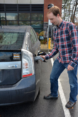 Arthur Bozogian, a SUNY Empire State College employee and resident of Saratoga Springs, recharges his hybrid vehicle at the new ChargePoint EV charging station at 113 West Ave., the college’s LEED Silver-certified facility. Bozogian was for the unveiling of the new recharging station, made possible by a public private partnership resulting from Gov. Andrew M. Cuomo’s Charge NY initiative.