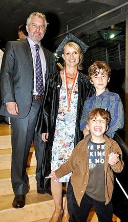 Graduate Melissa Stanley is surrounded by her husband Paul, at her left and sons Jephy and Zak