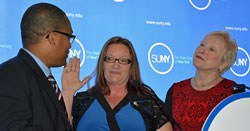 Chancellor Nancy L. Zimpher, at right, looks on with pride as Joel Pierre-Louis, secretary of The State University of New York Board of Trustees swears in Student Assembly of the State University of New York President and Empire State College student Lori Mould as the student trustee.