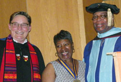 Theresa Carter (center) is flanked by Deborah Amory, acting provost for academic affairs and Dean Gary Lacy, during the 2014 Commencement Exercises in Harsdale.