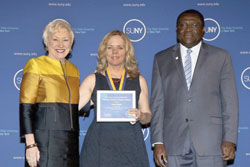 SUNY Chancellor Nancy L. Zimpher stands next Laura Dreyer ’14 who is holding her Chancellor's Award for Student Excellence. Zimpher and Dreyer were joined by the college's provost and vice president for academic affairs, Alfred Ntoko, at the 2015 award ceremony for all recipients held in Albany, N.Y./Photo Joe Putrock for SUNY