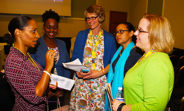 Professors Desalyn De-Souza, center, and Tracy Galuski, far right, participated in an early childhood development conference with the University of the West Indies.