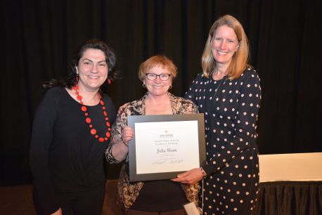 Professor Roxana Toma, left, and President Merodie Hancock present Professor Julie Shaw with the 2016 Susan H. Turben Award for Excellence in Scholarship. Toma is the 2015 award recipient.